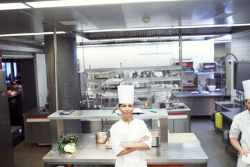 Chef, woman and confident in industrial kitchen, restaurant and gourmet meal prep and serving....