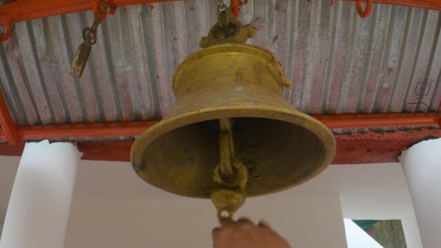 Hindu Temple Bell Closeup | Brass made bell is being rang by a person | Ringing bells - Selective focus.