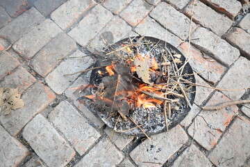 Smoldering wood fire. The fire is being kindled by blowing. Wooden fire.  Rural area in India.