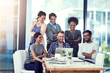 Business people, laptop and collaboration in office meeting for planning, conversation and communication. Happy, colleagues or diverse employee in group for reading ideas, teamwork or project