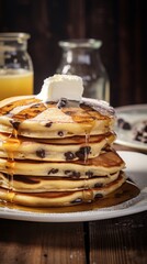 
delicious fluffy chocolate chip pancakes with the topping of butter and sugar syrup on a plate with a slice cut out