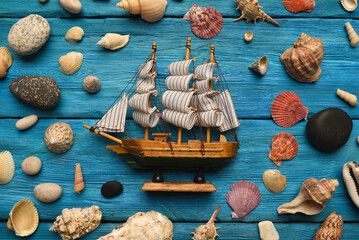 Sea travel background. SUmmer vacation concept flat lay background. Toy ship among scattered...