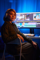 a woman wearing headphones is sitting in front of a computer