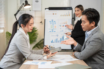 Asian businessmen, women and men Talk about new projects, presents at home office.