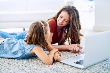 Mother, girl and laptop for homeschool in home, online class and remote learning or education on...