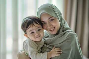 Mother in hijab embracing small son, both smiling. Asiatic family. Soft, natural light, pastel tones. Ideal for family, lifestyle ads.