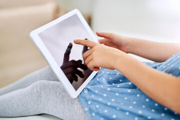 Hands, tablet screen and child in home on sofa for game, show or streaming movie in living room....