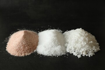 Different types of organic salt on black table