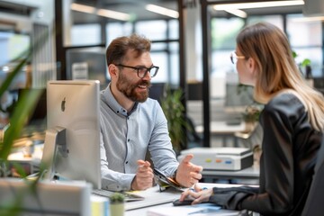 Young manager talking with experienced colleague while using computer in office, Generative AI
