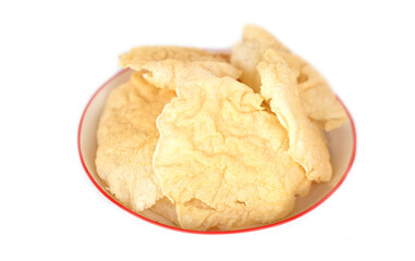 Homemade shrimp rice crackers on plate isolated on white background. Concept, Traditional Thai snack, made from dried dough and deep fry in hot oil to be crispy delicious snack.        