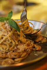 Rolling pasta with a spoon or fork