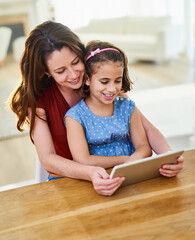 Mother, girl and tablet for movie in home, online play and remote learning or education at table....
