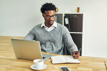 Business, black man and writing in office with laptop for daily schedule or planning and goal...