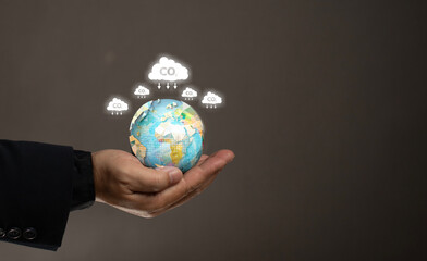 Carbon credit concept. Carbon neutral in industry and net zero emission eco energy. Reducing the amount of greenhouse gases. Man hold the globe and co2 icon. Climate pollution carbon dioxide.
