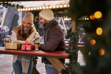 Caucasian couple on Christmas market with Christmas presents