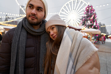 Caucasian couple looking at Christmas market