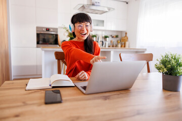 Woman having online meeting while working remotely from home