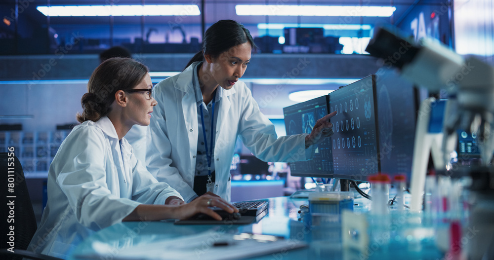 Poster asian and caucasian female doctors talking in medical research center and using desktop computer to 