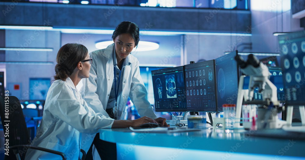 Poster asian and caucasian female doctors talking in medical research center and using desktop computer to 