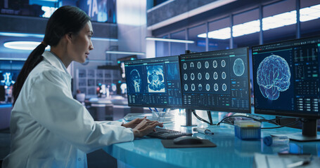 Hospital Research Laboratory: Asian Female Medical Scientist Using Computer with Brain Scan MRI...