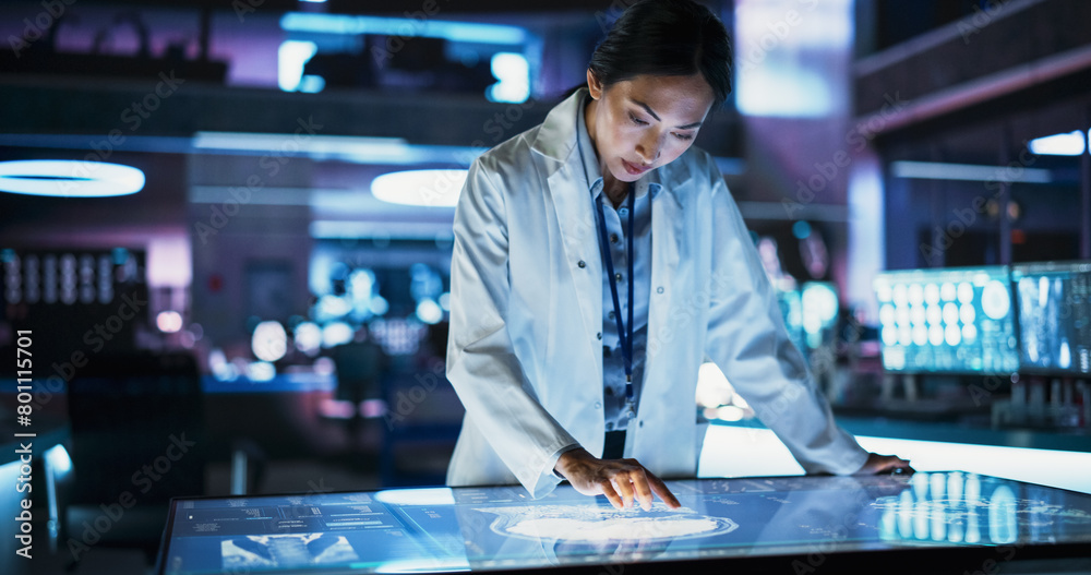 Aufkleber female asian neuroscinetist using interactive touch screen table with mri scans on display in modern