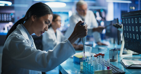 Pharmaceutical Research Laboratory: Female Asian Doctor Working With Test Tubes To Study Innovative...