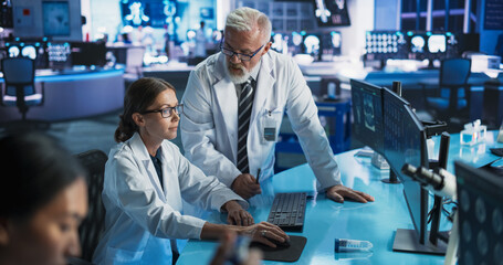Biotechnology Research Laboratory: Two Caucasian Doctors Discussing CT Brain Scan On Computer....