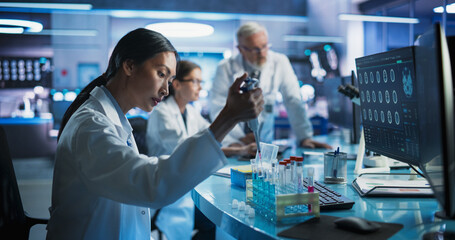 Pharmaceutical Research Laboratory: Female Asian Doctor Working With Test Tubes To Study Innovative...