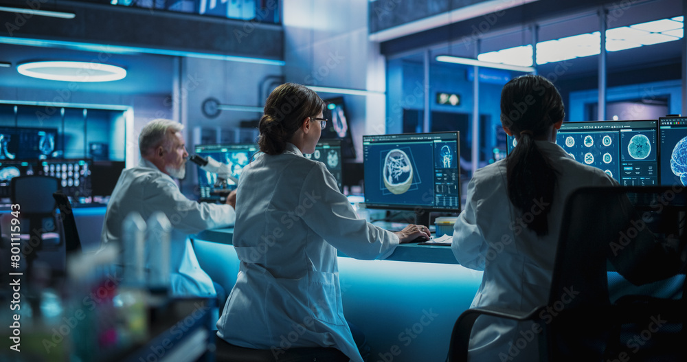 Aufkleber Back View Of Diverse Scientists Working In Medical Research Center. Male Doctor Using Microscope And His Female Colleagues Looking At CT Brain Scans On Desktop Computers. Biotechnology Lab Concept.