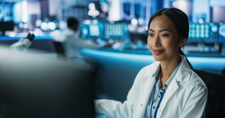 Portrait of Asian Female Doctor Using Desktop Computer In Modern Hospital Medical Research...