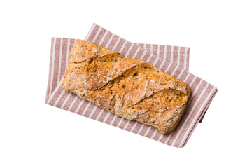 Freshly baked delicious french bread with napkin isolated on white background top view. Healthy white bread loaf
