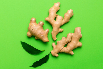 Finely dry Ginger powder in bowl with green leaves isolated on colored background. top view flat lay