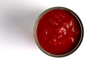 A tin of Italian chopped tomatoes in rich juice on a white background. Top view.