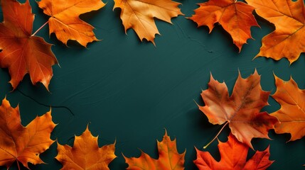 Scattered maple leaves in vibrant autumn colors over a dark green surface, embodying fall aesthetics.