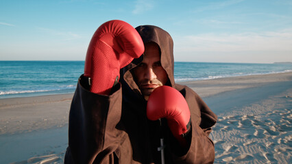 The Defense Pose For An Hooded Boxer Monk  - obrazy, fototapety, plakaty