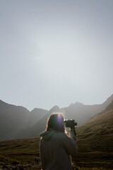 Woman filming in beautiful nature