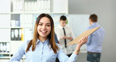 Portrait of happy woman working with smart colleagues in big modern building and participating in...