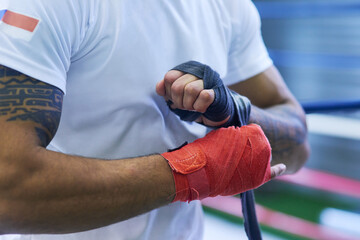 Gym, fighter or man wrapping hands for training, exercising and workout for competition....