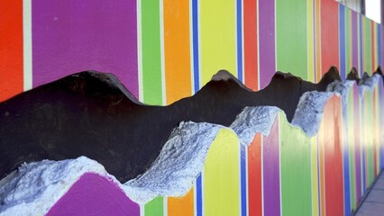 The deep crack on the multicolored wall. Concept of union and love between people of all sexual...