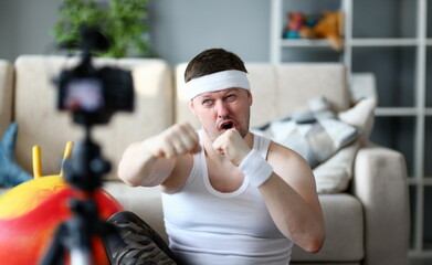 Bearded Man Recording Boxing on Digital Camera. Sportsman Shooting Video on Professional Camcorder...