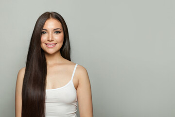 Brunette model woman with natural make-up, healthy skin and long hair. Female beauty, cosmetology and skincare concept