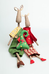 Christmas cozy hygge decor. Scandinavian textile toy elk on white background - obrazy, fototapety, plakaty