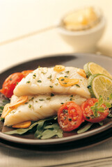 Two fresh cod fillets cooked in garlic