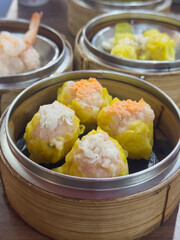 Shrimp shumai is a type of traditional Chinese dumpling. Chinese steamed dumpling in bamboo steamer.