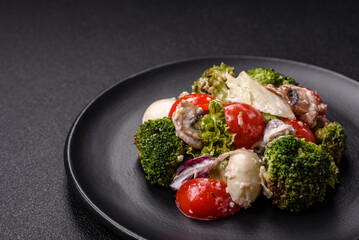 Delicious fresh juicy salad with quail eggs, cherry tomatoes, lettuce leaves