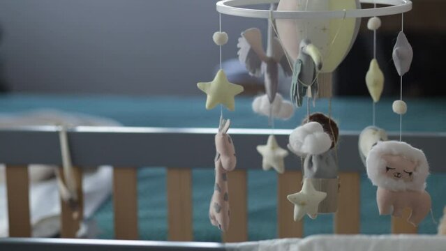 Beautiful baby mobile over crib, concept of restful sleep and first months of baby's life