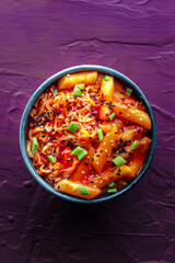 Rabokki, tteokbokki or topokki with ramen, Korean street food, spicy rice cakes in red pepper gochujang sauce, shot from the top