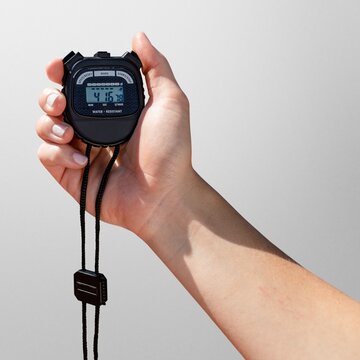 Hand holding stopwatch