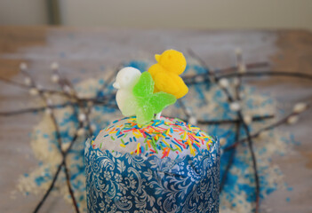 Easter cake (kulich)decorated with white sugar icing and yellow duck.