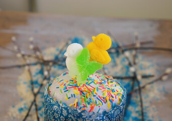 Easter cake (kulich)decorated with white sugar icing and yellow duck.